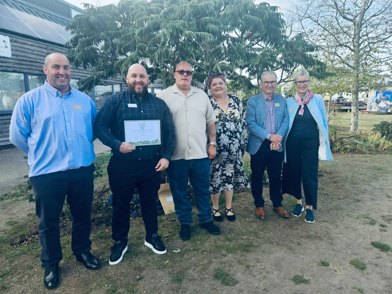 Henley's Bloom team with the 2026 Gold certificate: Clive Gibbs, Kyle Dowling (Parks Manager, holding the award), Alan Webb, Cllr Kellie Hinton (Chair of the Bloom committee) and Alan and Helen Gaynor (Northfield End Volunteers)